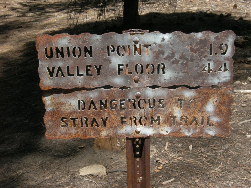 Mileage sign at the top of the Four Mile Trail