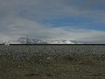 Tracks, Ballast, Marker Beacon, Mountains, Snow, and Clouds