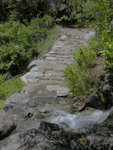 Water flowing over the trail