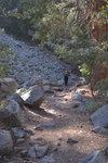 Hiker passing a small rock slide area